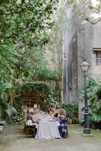 Stylish outdoor seated dinner in New Orleans Pharmacy Museum courtyard 
