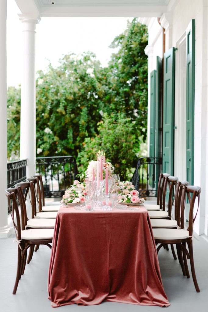long table with blush velvet linen and wooden chairs
