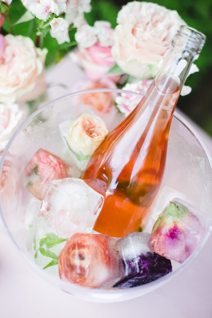 bottle of Rose in bucket of floral ice