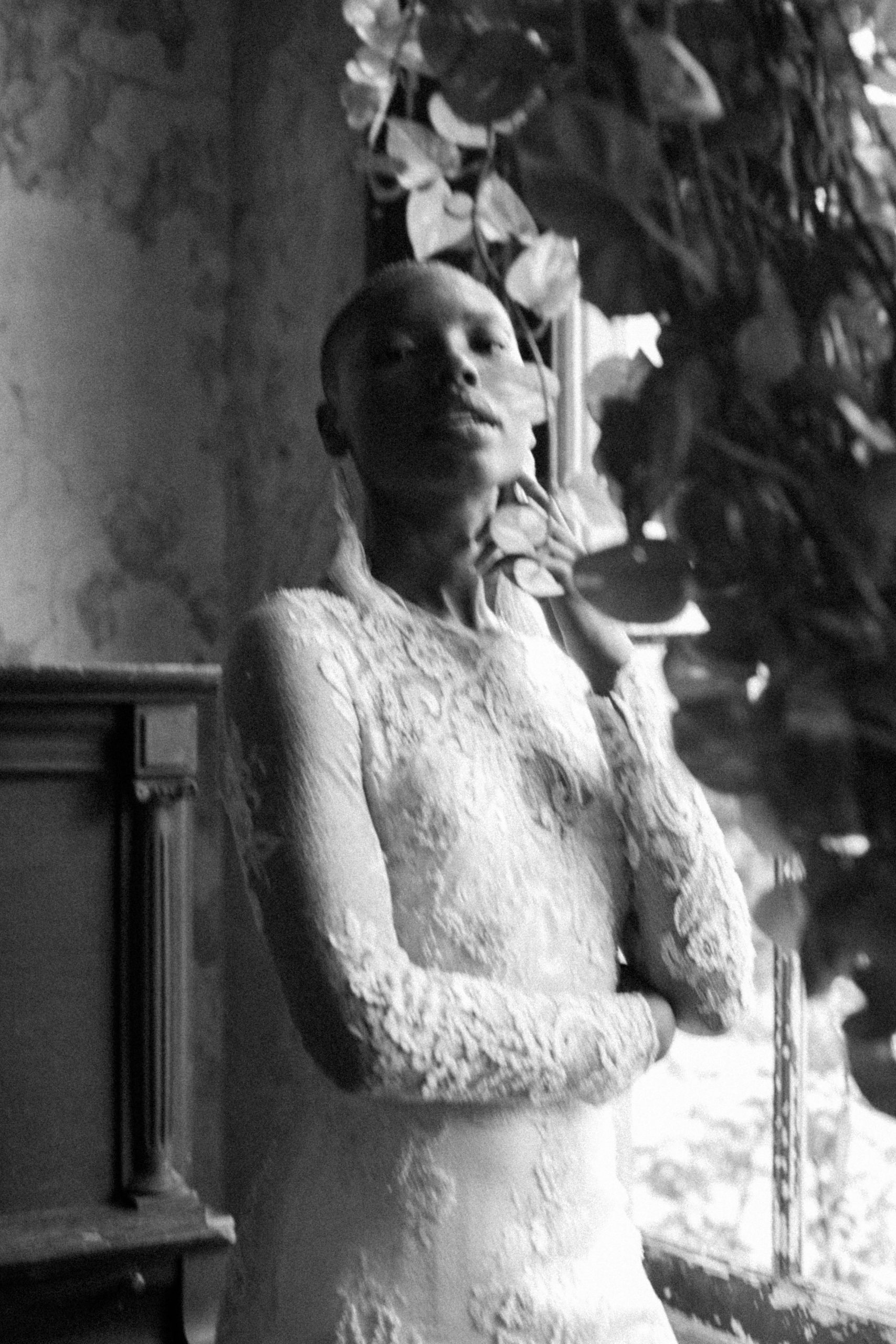 black and white image of women in long sleeve lace wedding down