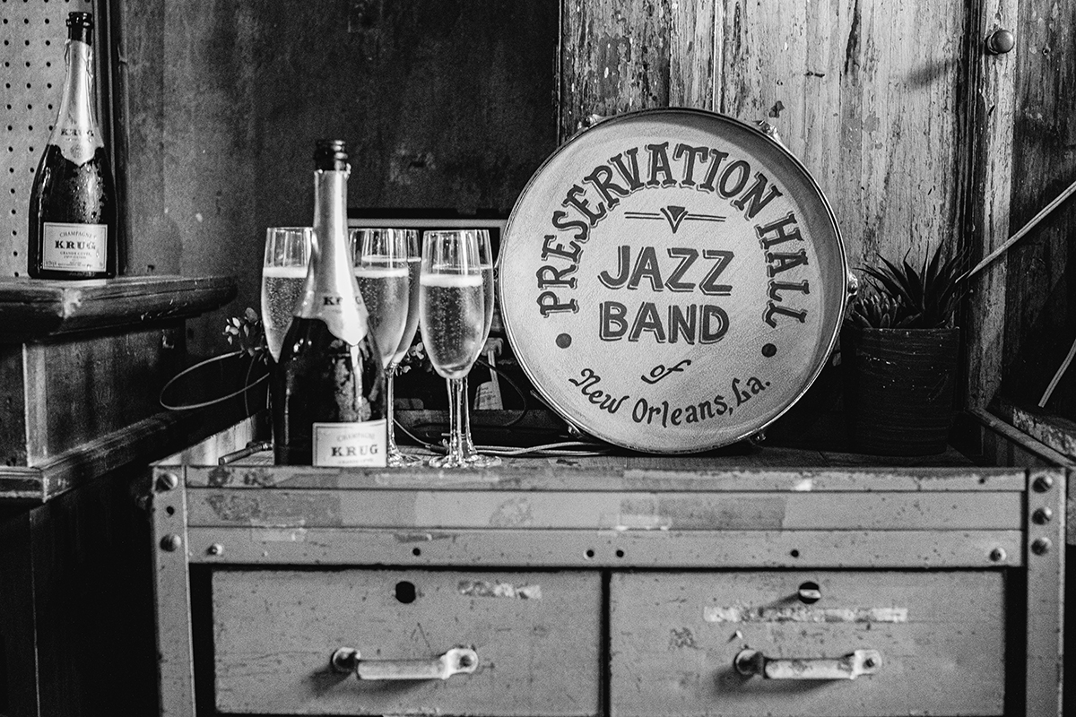 a bottle of Krug champagne and champagne filled flute stemware awaits guest arrival at Preservation Hall.